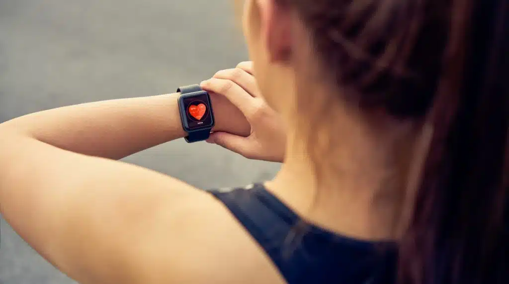 women measuring heart rhythm at home using ekg monitor